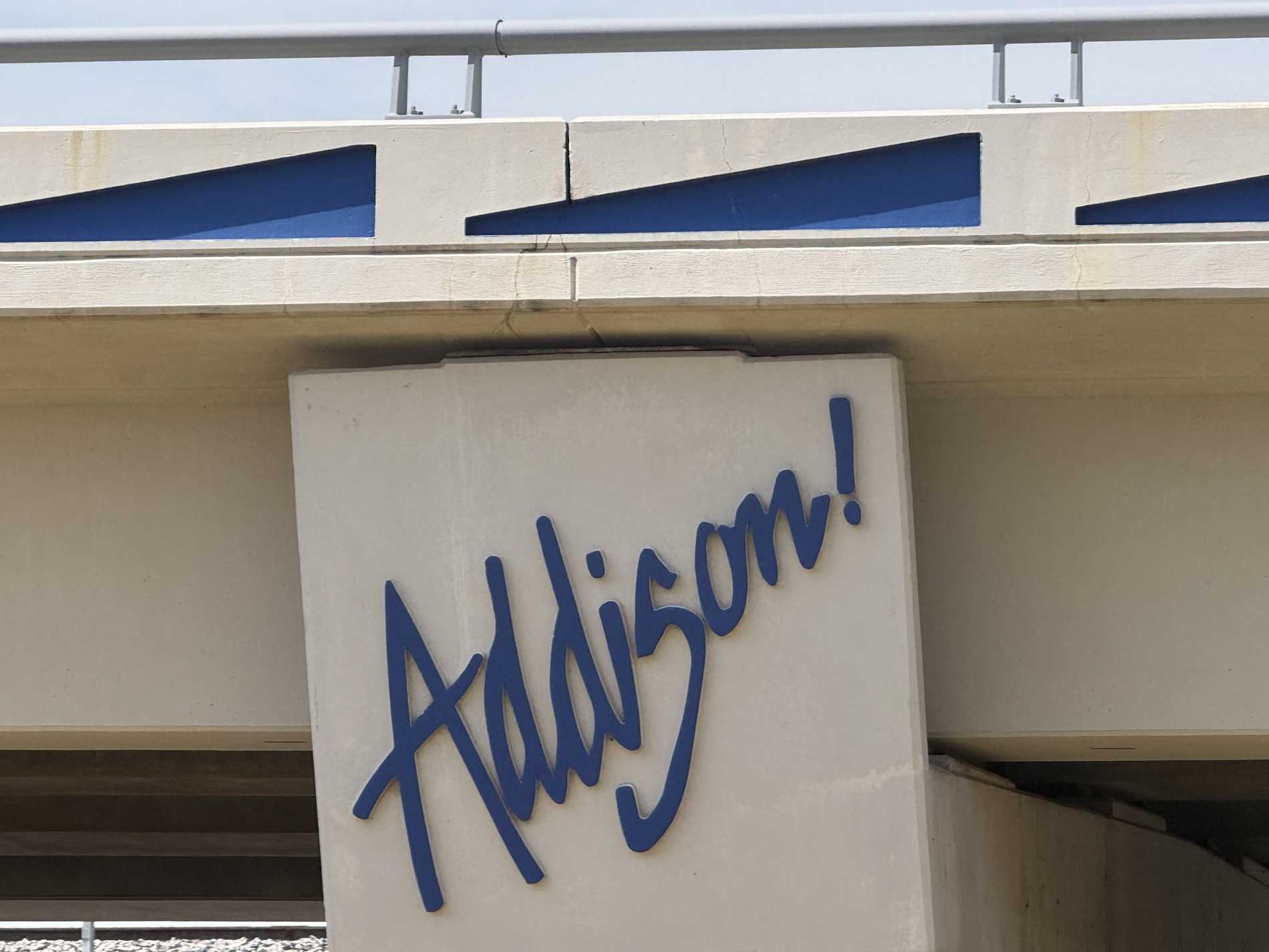 Addison Is About to Get Even More Walkable Close-up of the Addison! signage mounted on the bridge support column